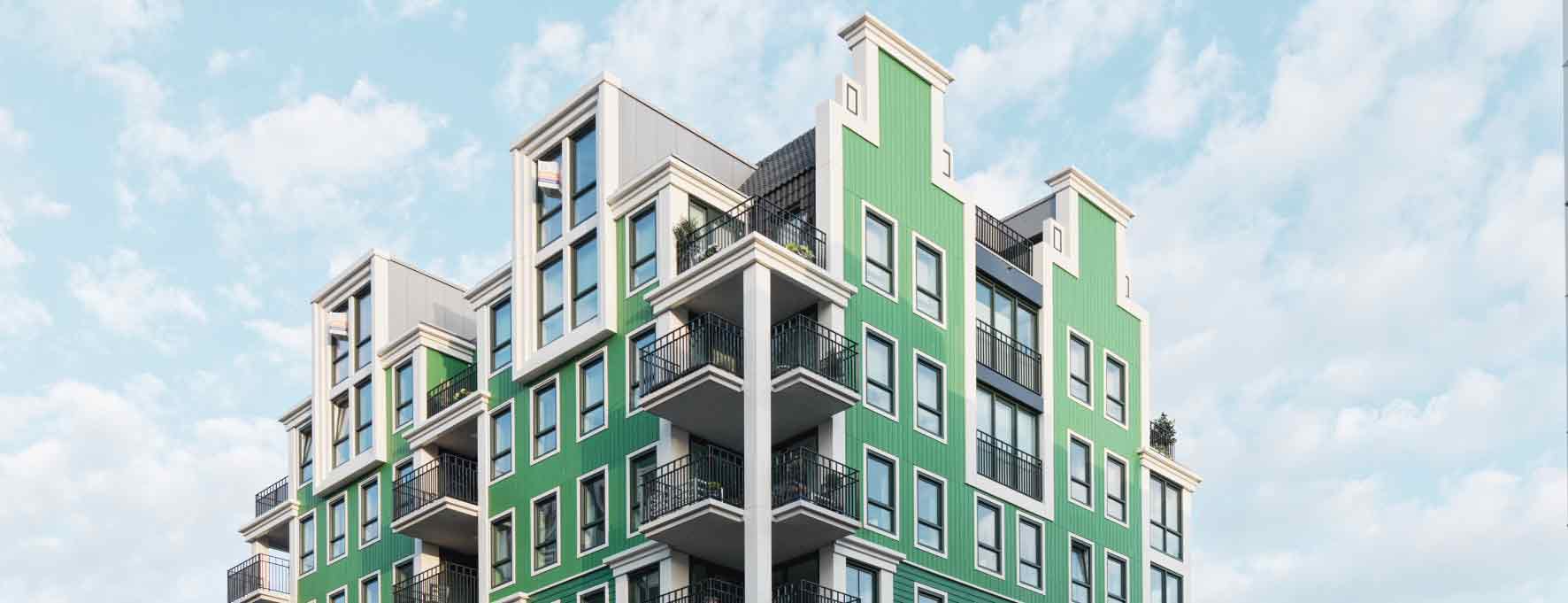 Apartment building with green and white facades and balconies